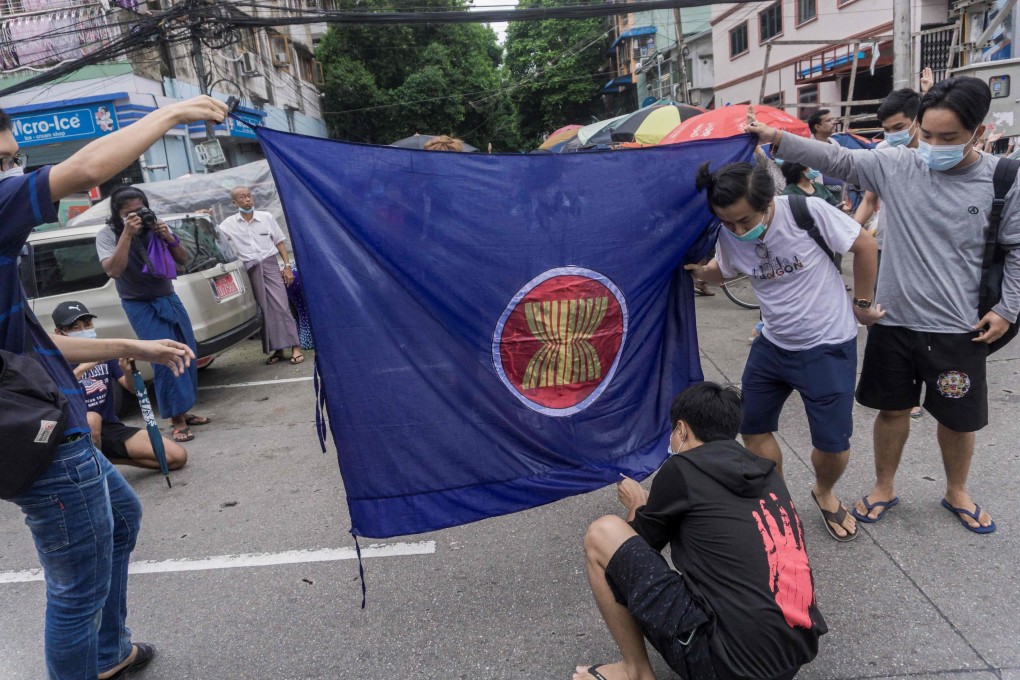 Protesters in Myanmar prepare to burn the Asean flag. US Secretary of State Antony Blinken is taking part in a week of talks involving foreign ministers of the Association of Southeast Asian Nations, of which Myanmar is a member. Photo: AFP
