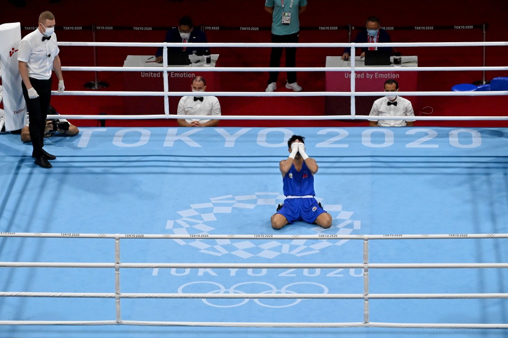 Philippines Carlo Paalam celebrates his victory over Uzbekistan’s Shakhobidin Zoirov in the flyweight quarter-finals at Kokugikan Arena. Photo: Luis Robayo - Pool/Getty Images