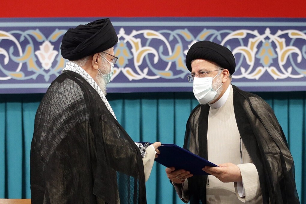 Iran’s supreme leader Ayatollah Ali Khamenei hands over the presidential precept to new president Ebrahim Raisi. Photo: EPA