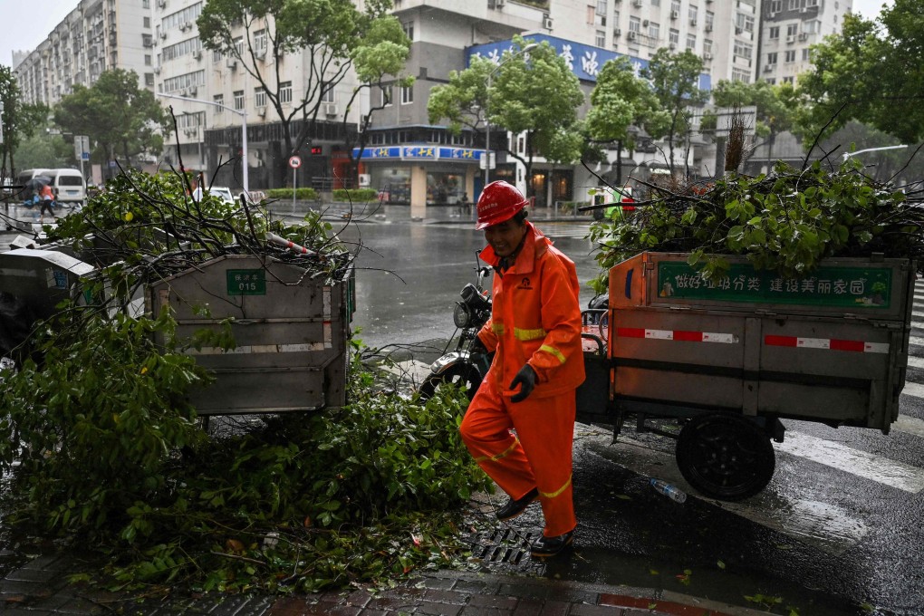 A worker clears fallen tree branches in Ningbo ahead of Typhoon In-fa's arrival. Photo: AFP