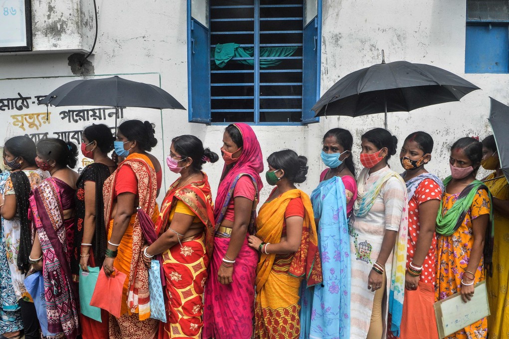 People wait to receive a Covishield vaccine dose in Siliguri, India. Photo: AFP