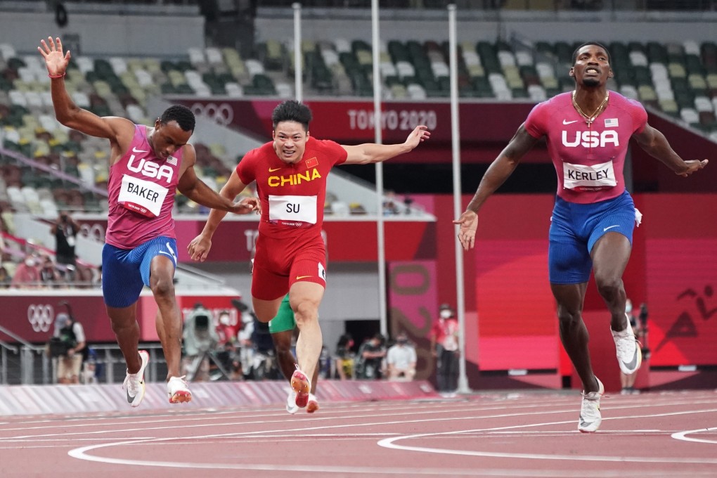 Su Bingtian of China crosses the 100m finish line behind US sprinters Ronnie Baker and Fred Kerley, at the Olympic Stadium in Tokyo on August 1. Photo: Reuters