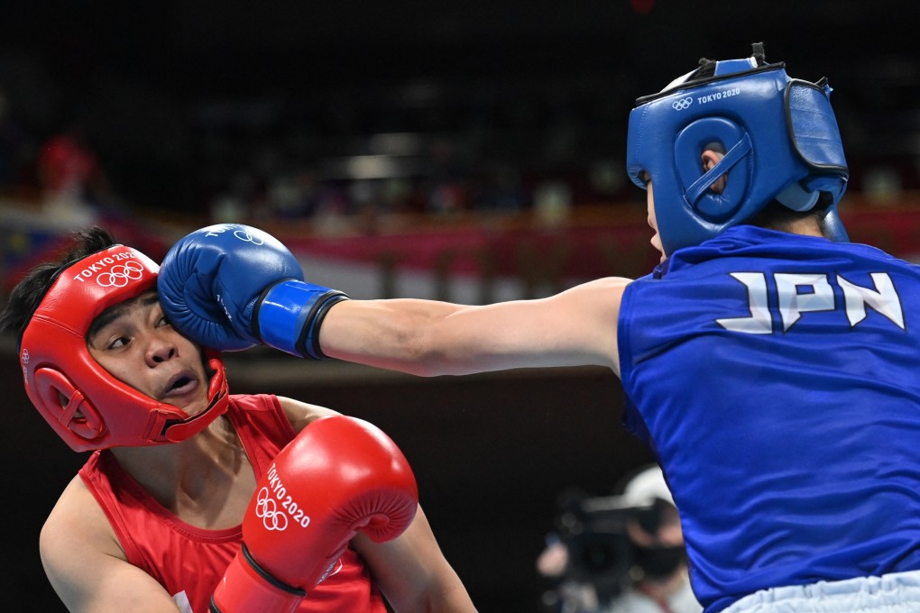 Philippines Nesthy Petecio is caught by a long-range jab from Japan’s Sena Irie in the featherweight gold medal bout. Photo: AFP