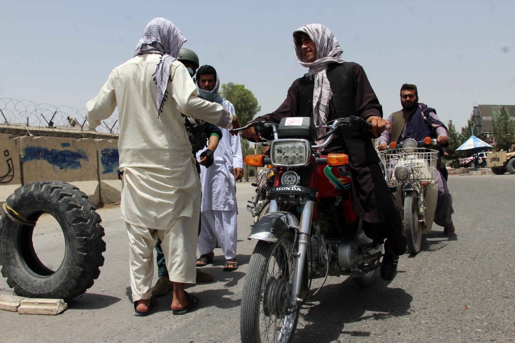 Afghan security officials check people on a roadside checkpoint in Kandahar, Afghanistan on Sunday. Photo: EPA-EFE