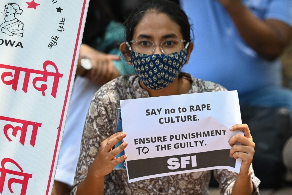 Activists hold placards during a protest against the alleged rape and murder of a girl. Photo: AFP