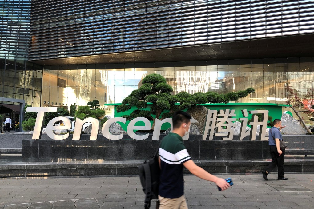 People walk past a Tencent sign at the company headquarters in Shenzhen. Photo: Reuters
