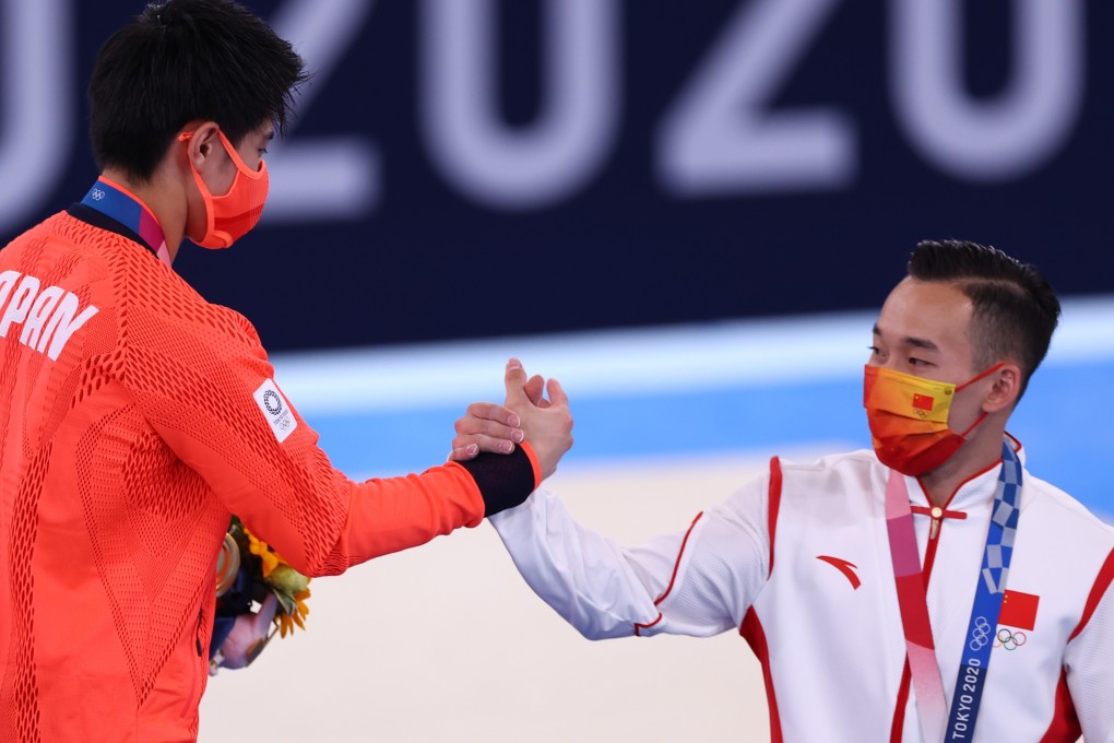 Gold medallist Daiki Hashimoto of Japan shakes hands with silver medallist Xiao Ruoteng of China after the men’s all-around gymnastics final. Photo: Reuters