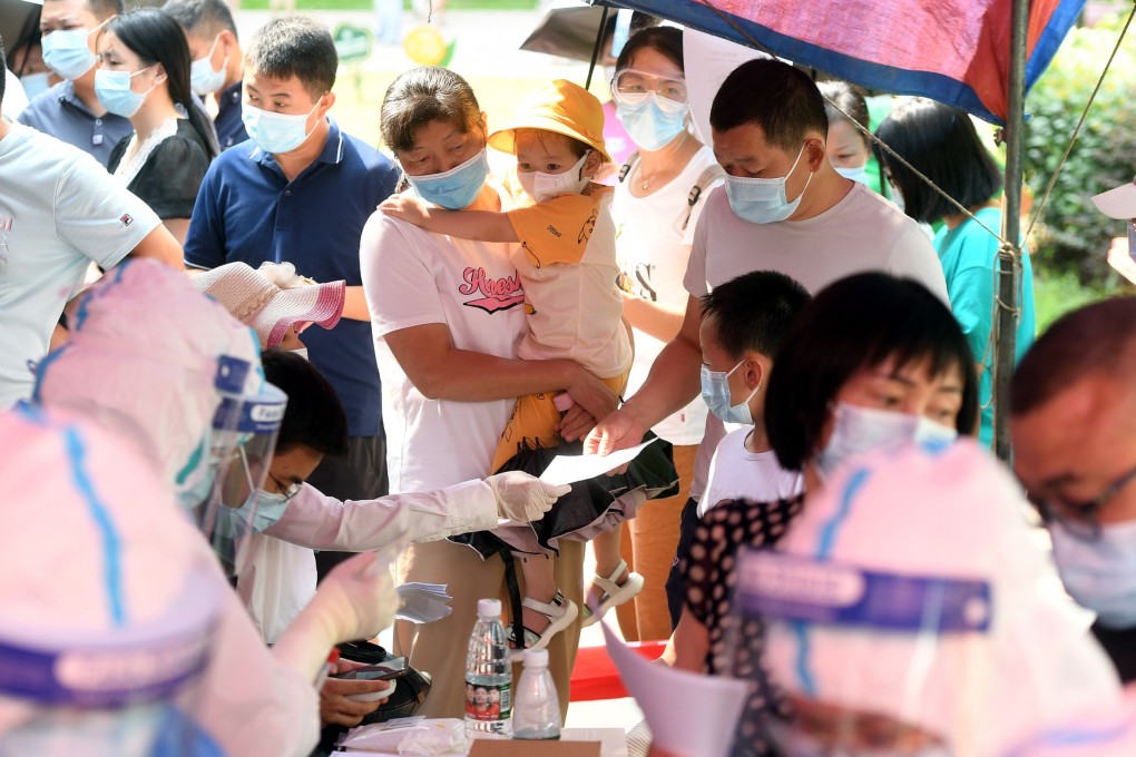 Residents line up to get tested for Covid-19 at a residential block in Wuhan, Hubei on Tuesday. The entire population of 11 million is being tested after new infections were detected in the city. Photo: EPA-EFE