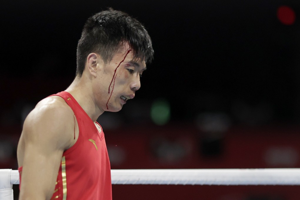 Hu Jianguan of China sustains an injury during his fight against Ryomei Tanaka of Japan. The Chinese boxer has posted of his fury at the decision against him. Photo: Reuters