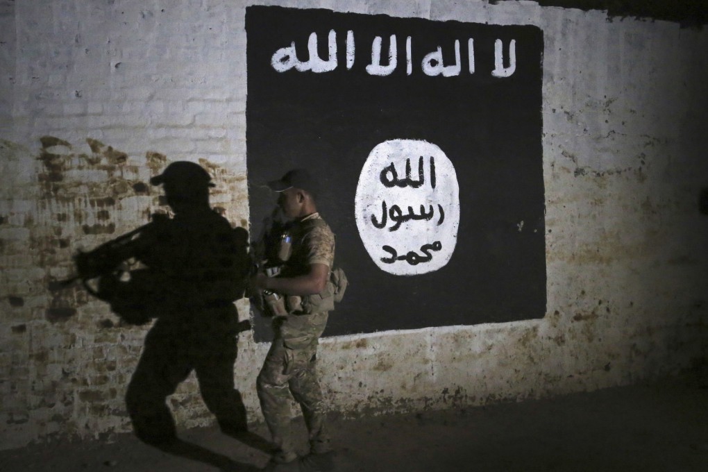 An Iraqi soldier inspects a train tunnel, adorned with an Isis flag, in Mosul in 2017. File photo: AP