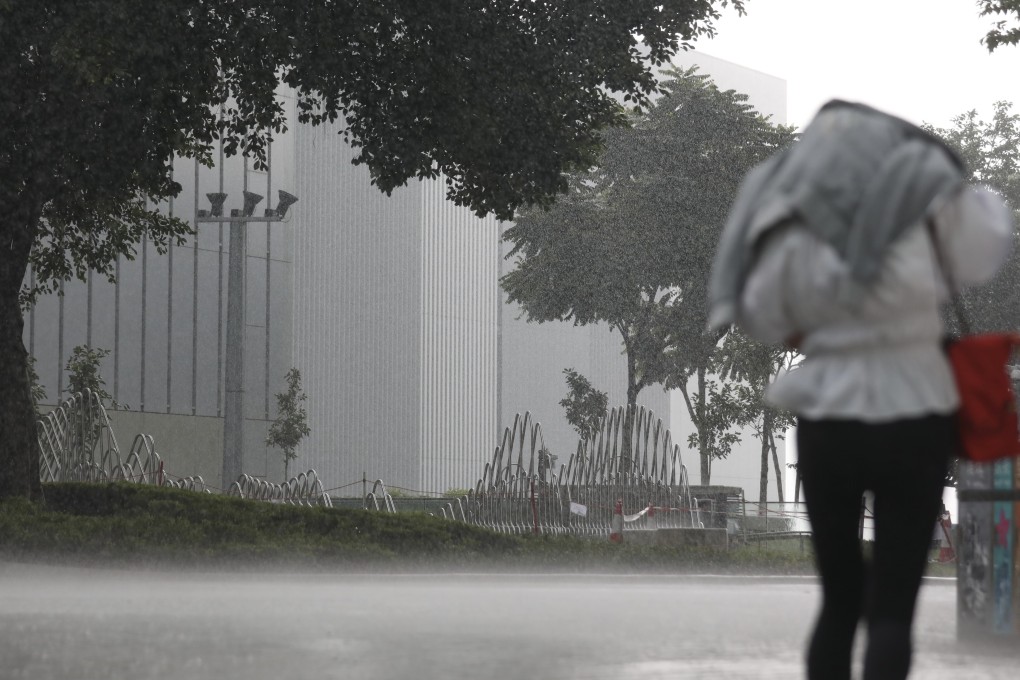 A person walks through Admiralty during a downpour on Wednesday. Photo: Xiaomei Chen