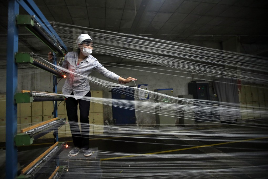 A textile worker at a factory in Wuhan, Hubei province, which is spearheading a plan to provide additional support to various sectors, including the textile industry. Photo: Reuters