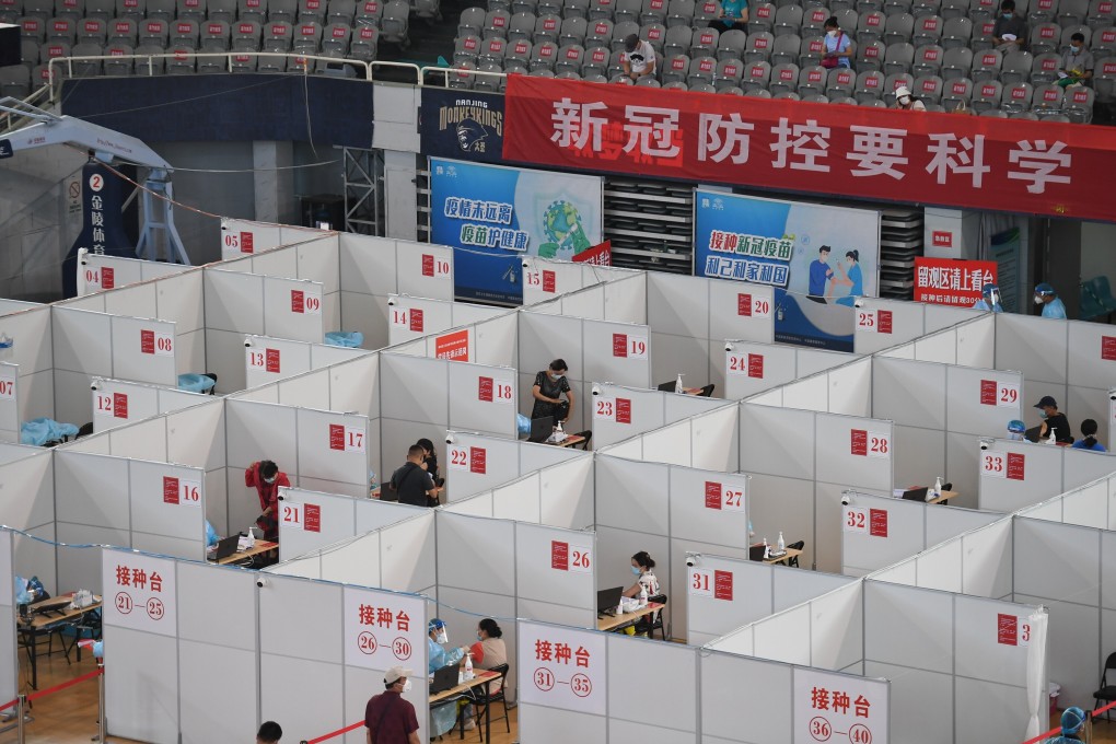 Residents are vaccinated at a stadium in Nanjing, Jiangsu. The latest outbreak has now spread to more than 10 provinces. Photo: Xinhua