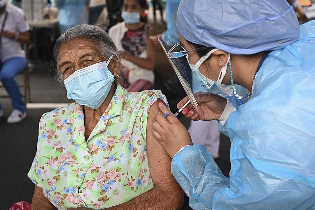 A woman receives a Moderna Covid-19 vaccine shot in Honduras. Photo: AFP