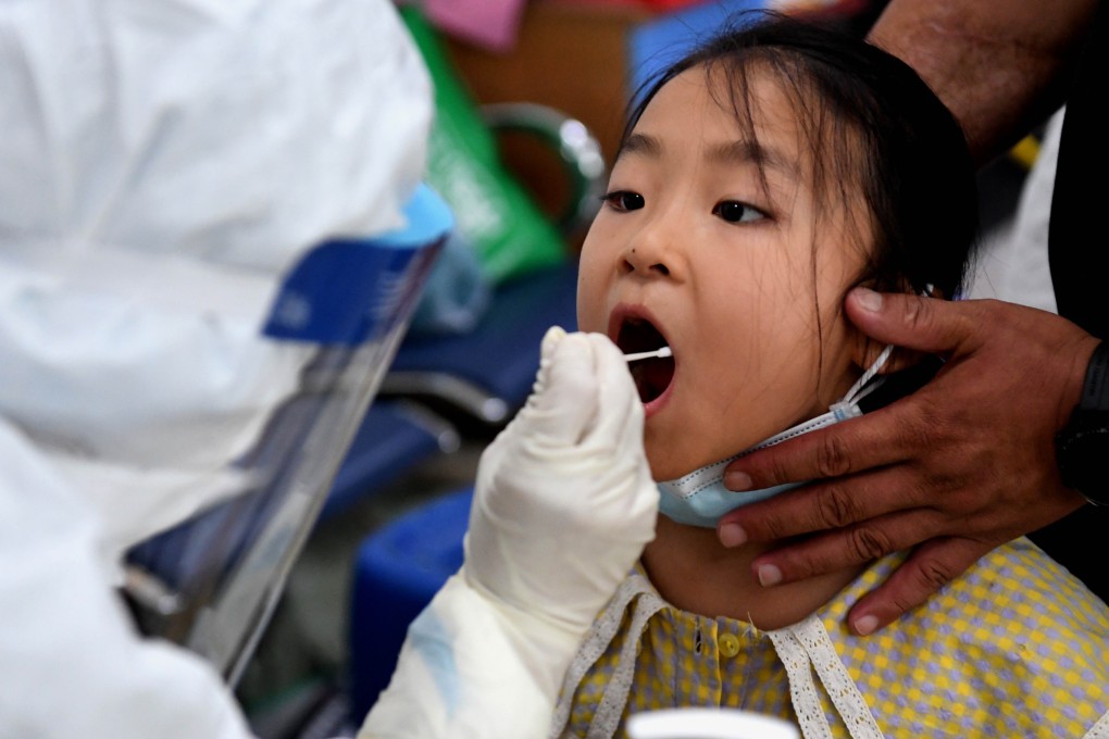A medical worker tests a child for Covid-19 in the Erqi District of Zhengzhou, in central China's Henan province. Photo: Xinhua