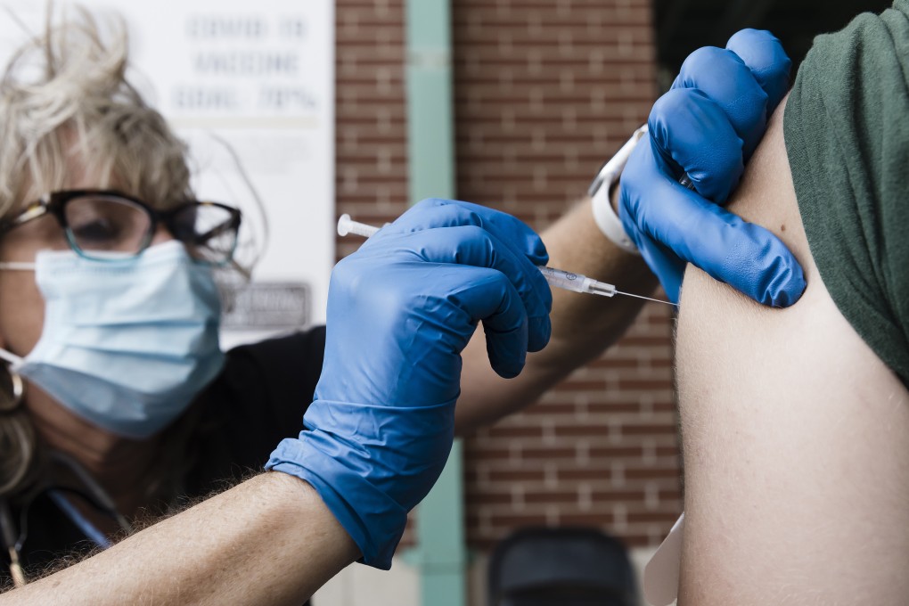 A health care worker administers a dose of the Pfizer-BioNTech Covid-19 vaccine in the US, which bought an additional 200 million doses. Photo: Bloomberg