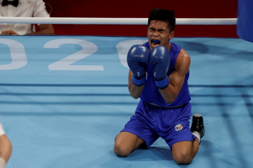 Carlo Paalam of the Philippines reacts after winning his quarter-final fight against Shakhobidin Zoirov of Uzbekistan. Photo: Reuters