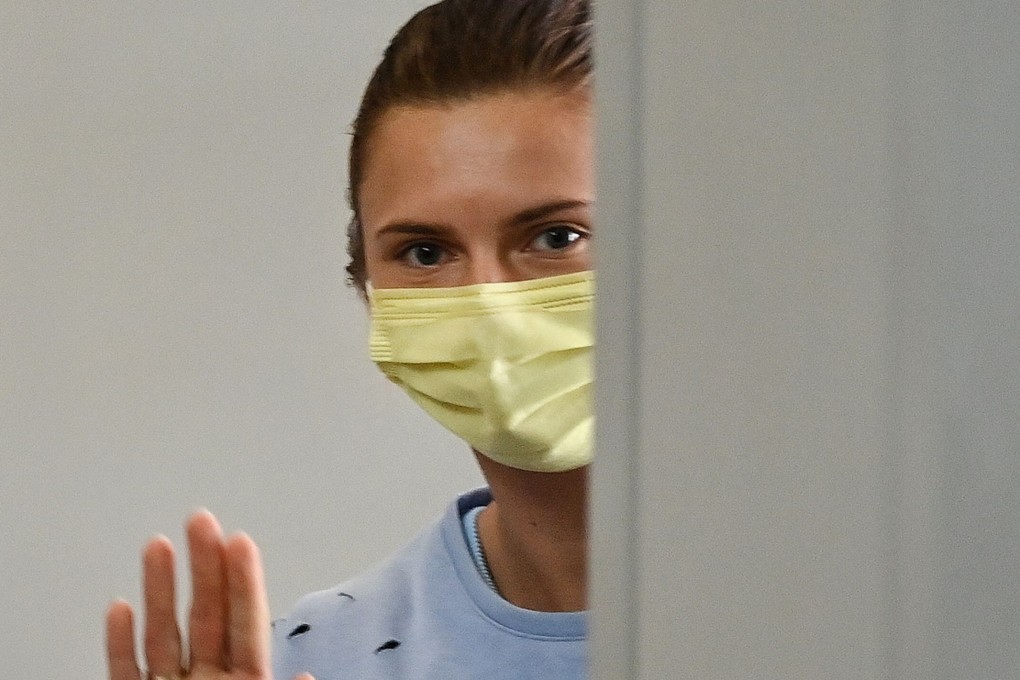 Belarus athlete Krystsina Tsimanouskaya waves goodbye as she boards her flight at Narita International Airport in Tokyo. Photo: AFP