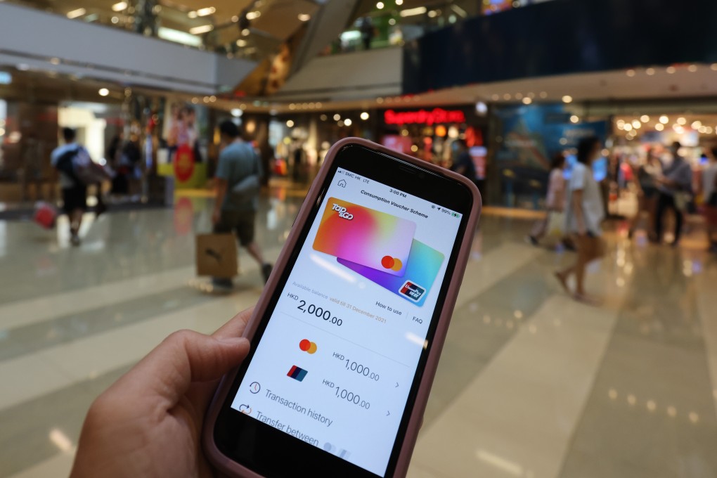 A consumer launches his Tap & Go e-wallet disbursed with shopping vouchers worth HK$2,000, at Cityplaza in Taikoo Shing. Photo: May Tse