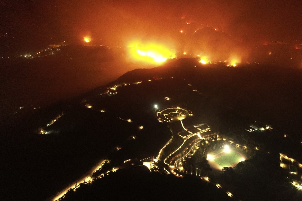 A wildfire approaches the Olympic Academy, foreground, in ancient Olympia, Greece, on Wednesday. Photo: AP