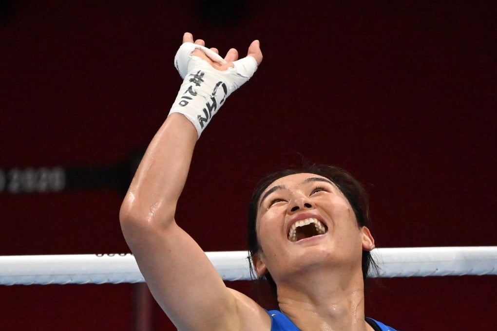China’s Li Qian celebrates after winning her quarter-final bout against India’s Pooja Rani. Photo: AFP