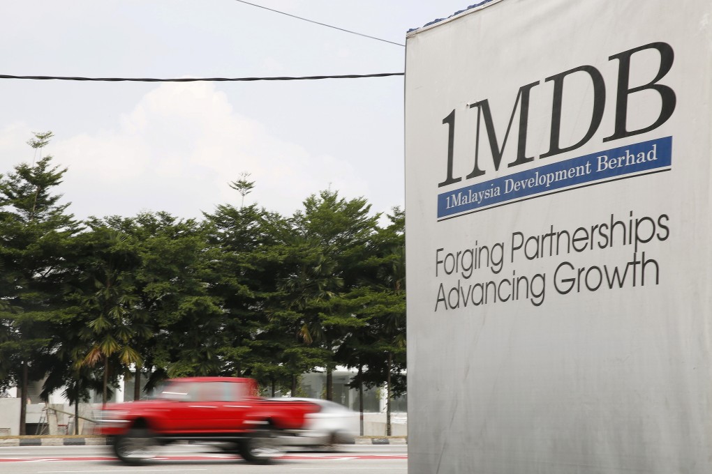 Traffic passes a 1MDB billboard at the Tun Razak Exchange development in Kuala Lumpur, Malaysia in July 2015. Photo: Reuters