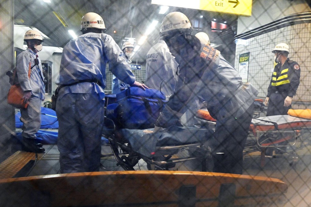 Rescuers prepare stretchers at Soshigaya Okura Station, Tokyo, after a stabbing on a commuter train on Friday. Photo: Kyodo News via AP