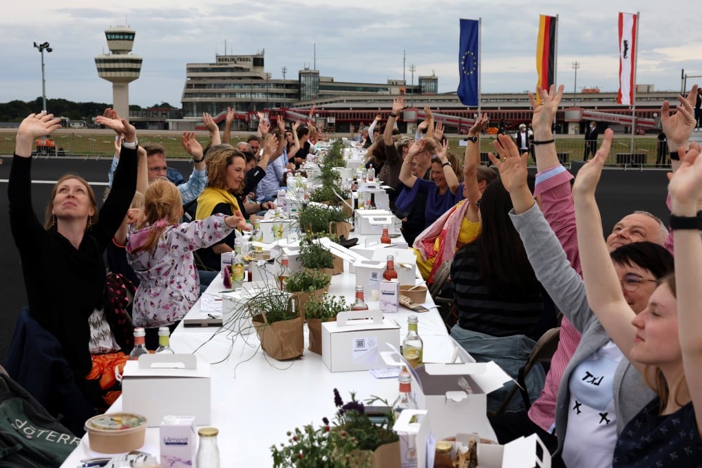 People take part in an open-air Freedom Dinner organised by Berlin’s Senate on the runway of the former Tegel Airport in Berlin, Germany on Saturday. Photo: Reuters