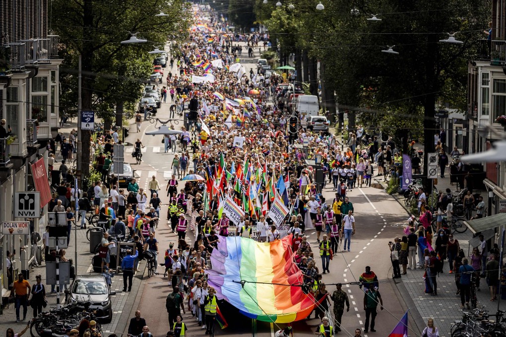 Participants with rainbow flags take part in the Pride march in Amsterdam on Saturday. Photo: ANP / AFP