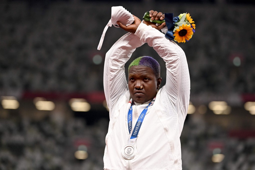 American silver medallist Raven Saunders makes an X sign with her arms while on the podium. Photo: AFP