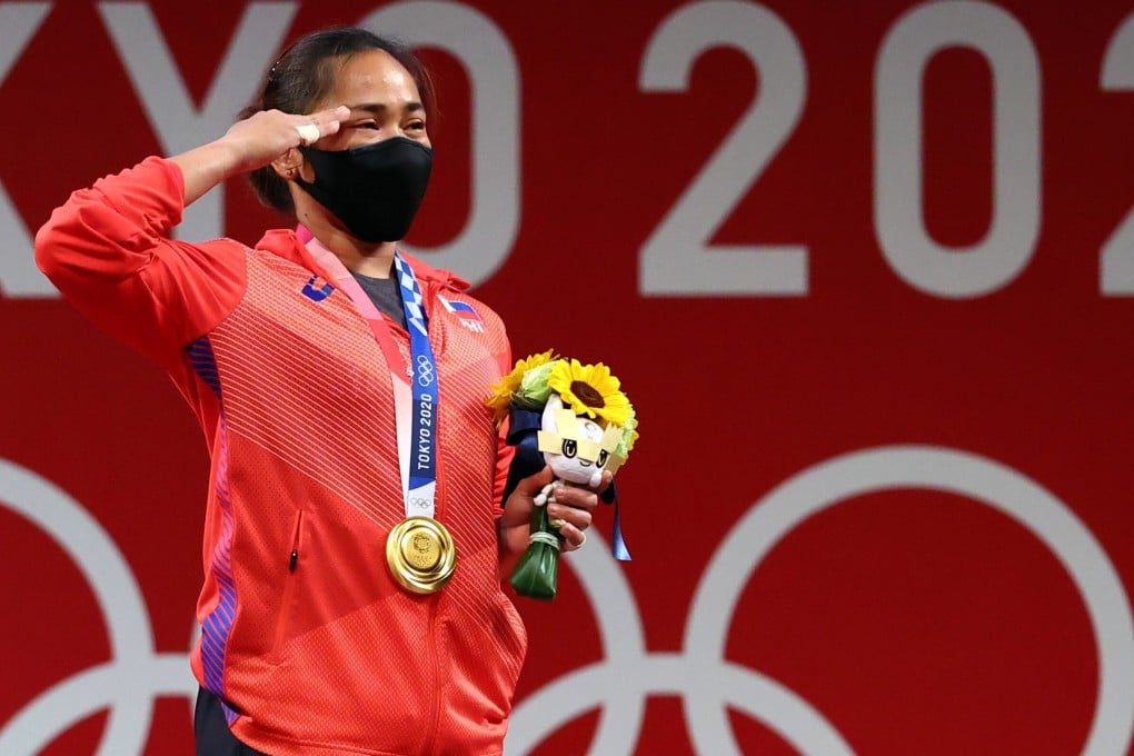 Gold medallist Hidilyn Diaz of the Philippines salutes on the podium at the Tokyo Olympics, after winning the country’s first gold medal. Photo: Reuters