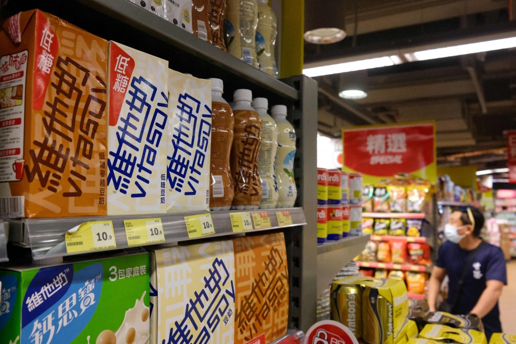 Soy milk drinks produced by local beverage brand Vitasoy (L) are displayed on a supermarket shelf in Hong Kong on July 5, 2021. Photo: AFP