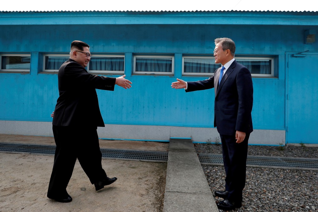 North Korean leader Kim Jong-un and South Korean President Moon Jae-in prepare to shake hands at the border village of Panmunjom in 2018. Photo: Korea Summit Press Pool via Reuters