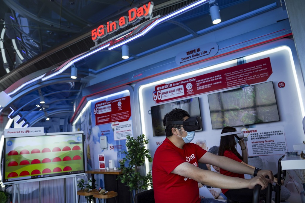 Staff demonstrate a VR cycling system during a media tour of SmarTone 5G Lab at Sky 100 at the International Commerce Centre in Hong Kong on May 1. Telecoms companies are betting on virtual and augmented reality to help recoup the costs of building 5G networks. Photo: SCMP/Sam Tsang