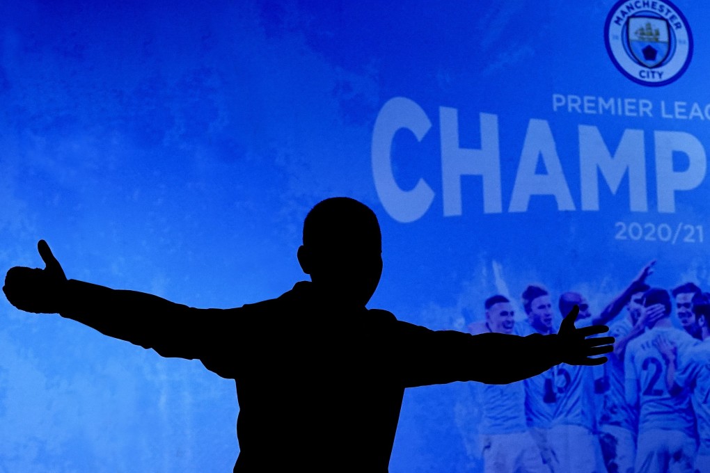 A Manchester City supporter celebrates outside the Etihad Stadium in Manchester after his team clinched the English Premier League title. Photo: AP