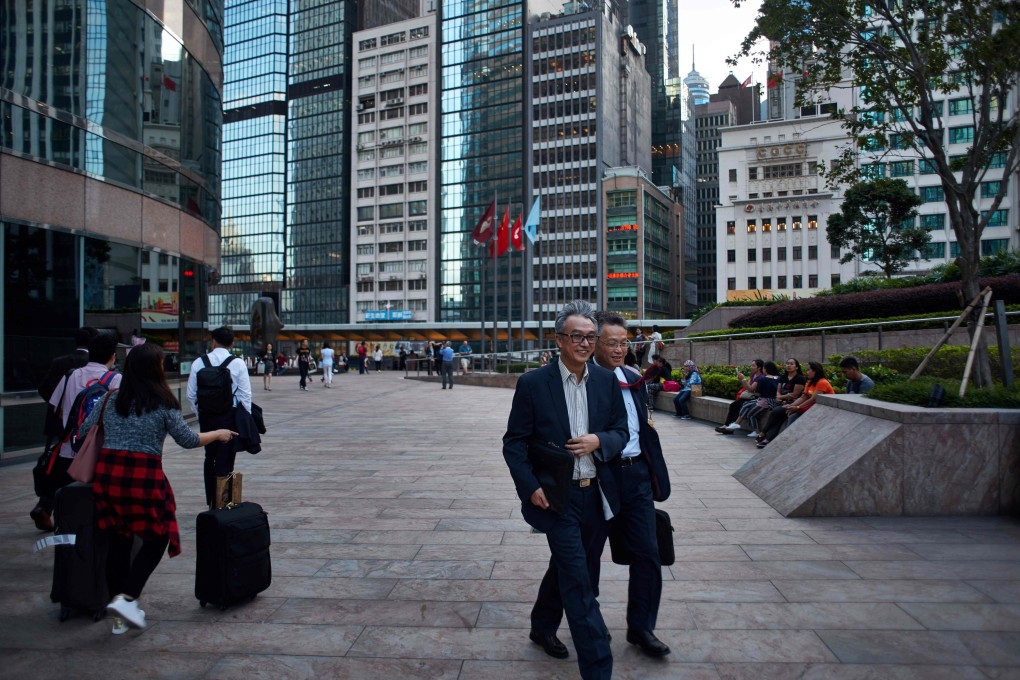 Pedestrians seen outside the Exchange Square in Central, where the Hong Kong stock exchange is located. Photo: AFP