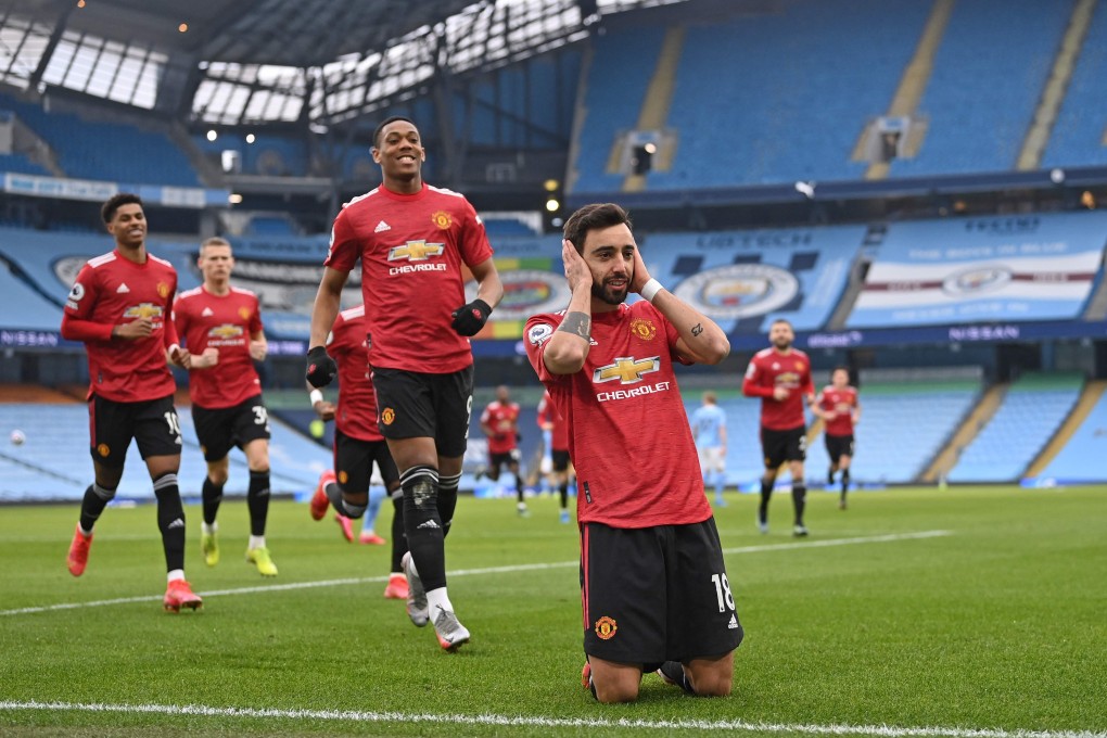 Manchester United's Portuguese midfielder Bruno Fernandes celebrates with teammates after scoring the during the English Premier League match against Manchester City. Photo: AFP