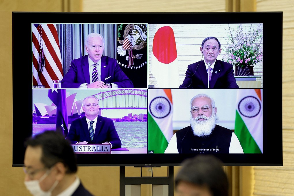 A monitor displaying the March 12 virtual Quad meeting of, clockwise from top left, US President Joe Biden, Japanese Prime Minister Yoshihide Suga, Indian Prime Minister Narendra Modi and Australian Prime Minister Scott Morrison. A follow-up meeting Thursday by senior officials of the four nations strengthened the alliance. Photo: AFP