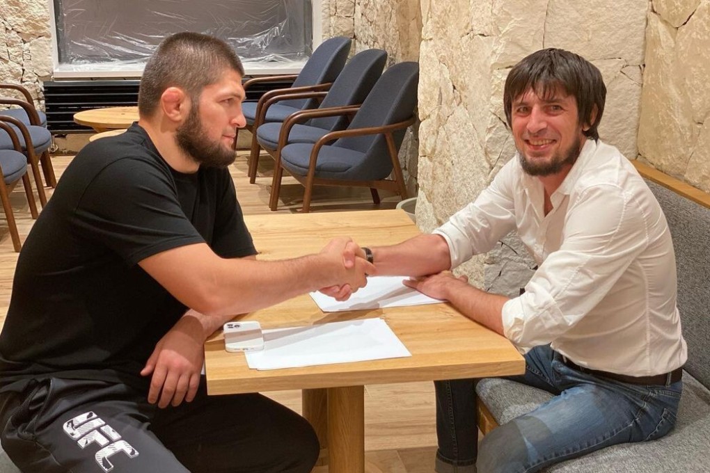 Khabib Nurmagomedov shakes hands with the president of Russian football club Legion Dynamo. Photo: Instagram/@fc_legion_05