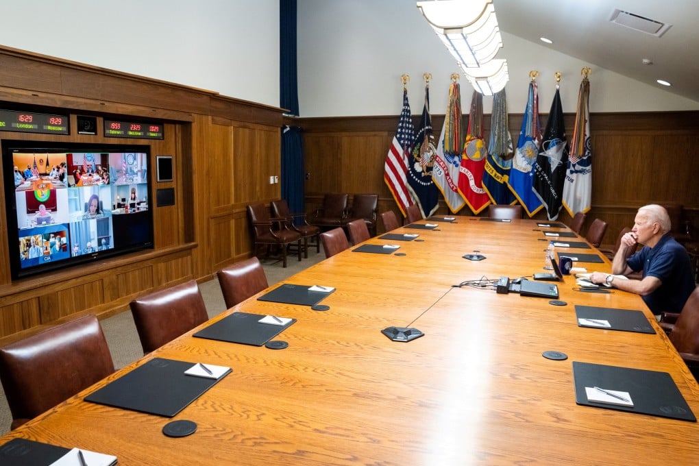 The White House released a photo of President Joe Biden at Camp David, staring pensively at officials on a monitor, surrounded by empty seats. Photo: Reuters