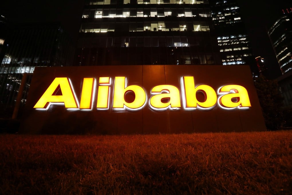 The logo of Alibaba Group lit up at its office building in Beijing on August 9. Alibaba has launched a section of its auction platform where artists can sell the rights to works using NFTs. Photo: Reuters