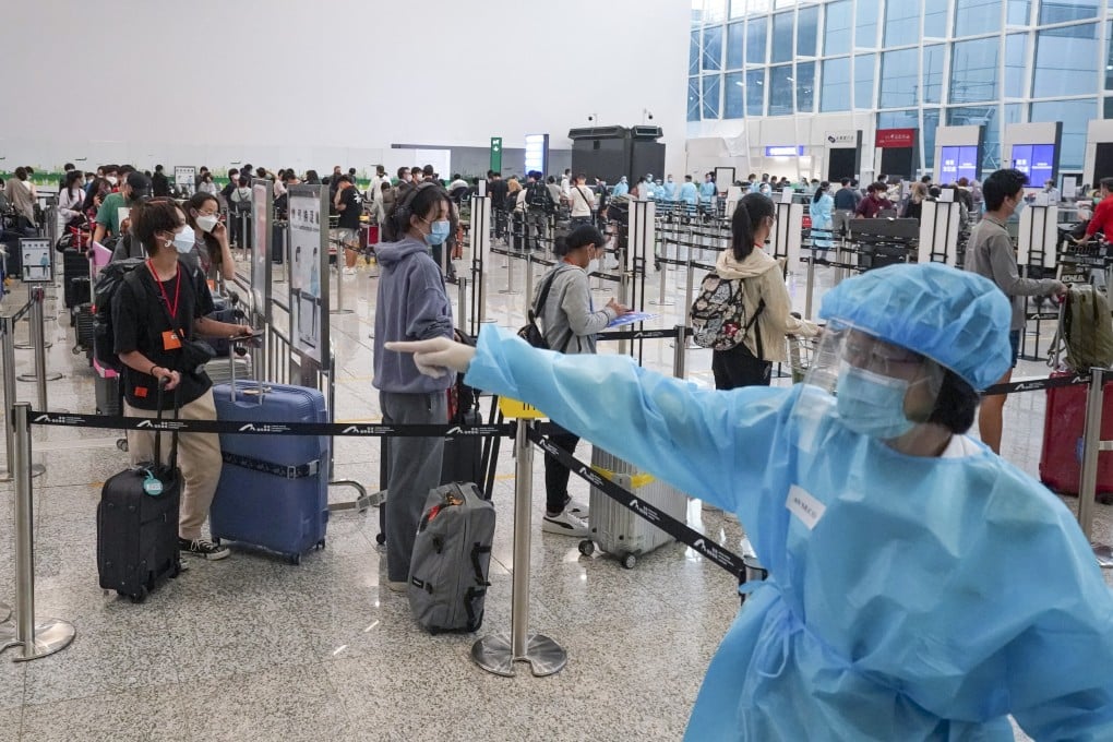 Passengers at Hong Kong International Airport wait to be transported to designated quarantine hotels. Photo: Felix Wong