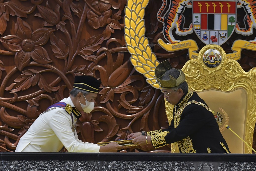 Malaysia’s king, Sultan Abdullah Sultan Ahmad Shah (right) receives documents from Prime Minister Muhyiddin Yassin during the opening ceremony of a parliamentary session last year. Photo: AP