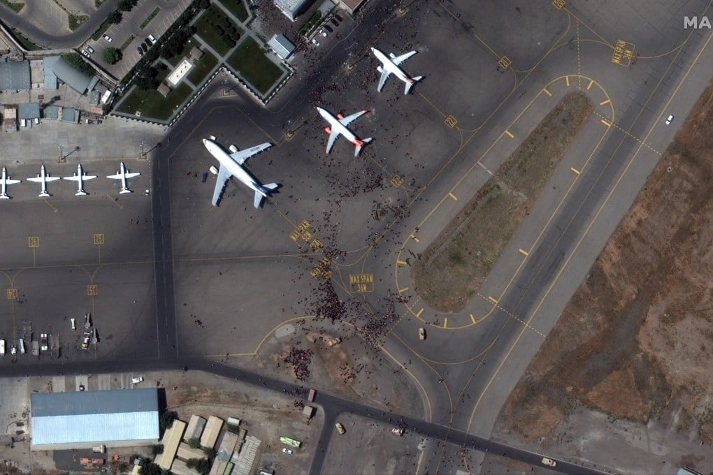 Crowds of Afghans surrounding a plane at Kabul’s airport on Monday. Photo: 2021 Maxar Technologies