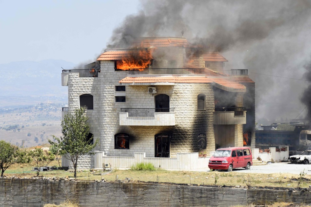 Smoke billows from the reported home of the lot owner where an exploded fuel tank was placed in the village of Tlel in Lebanon’s northern region of Akkar on Sunday. Photo: AFP