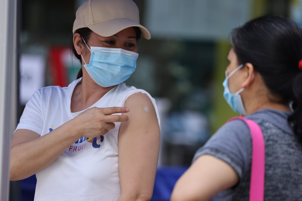 Two foreign domestic helpers after receiving their second dose of BioNTech vaccination for Covid-19 at Sun Yat Sen Memorial Park Sports Centre in Sai Ying Pun. Photo: Nora Tam