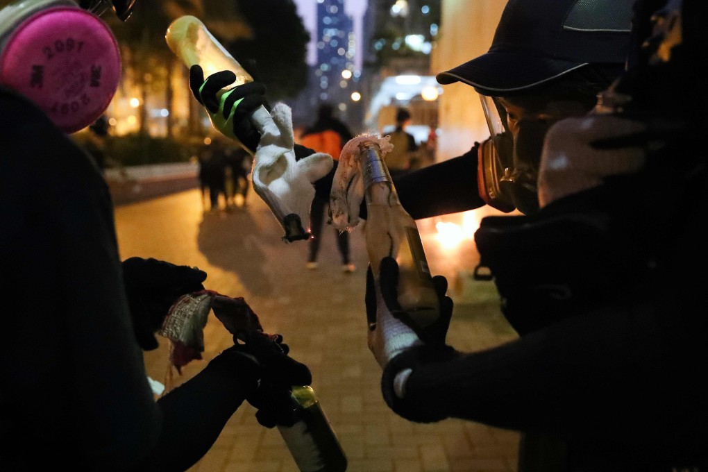 Protesters prepare petrol bombs in the Sham Shui Po district of Hong Kong during violent demonstrations on October 1, 2019. Photo: AFP