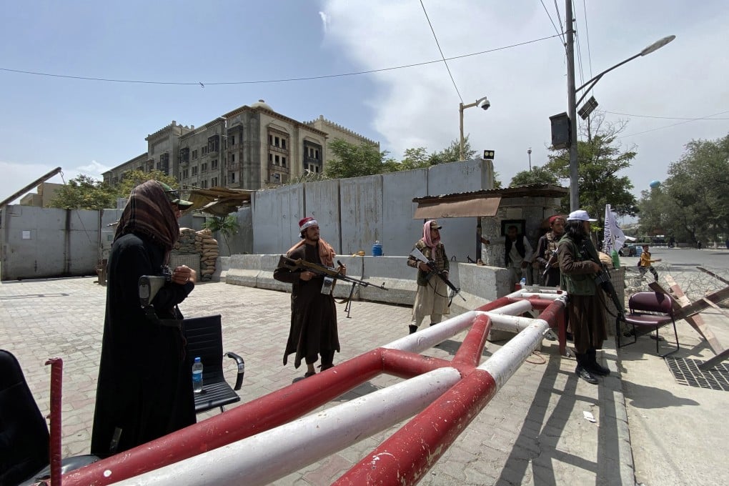 Taliban fighters stand guard on Tuesday outside the Green Zone of Kabul where most embassies are situated, a day after the insurgent group took control of the Afghan capital. Photo: EPA-EFE