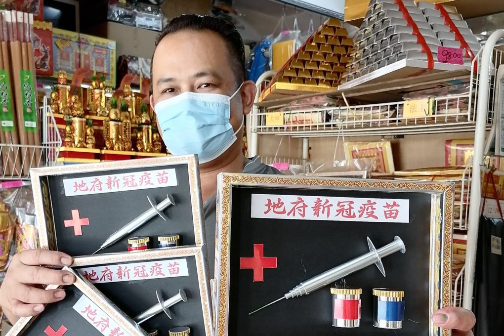 Raymond Shieh poses with his ‘Hell Covid-19 Vaccine’ set for the Hungry Ghost Festival at his shop in Johor Baru. Photo: Facebook