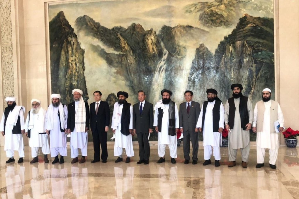 Chinese Foreign Minister Wang Yi (centre) welcomes a Taliban delegation in Tianjin last month. Photo: Twitter
